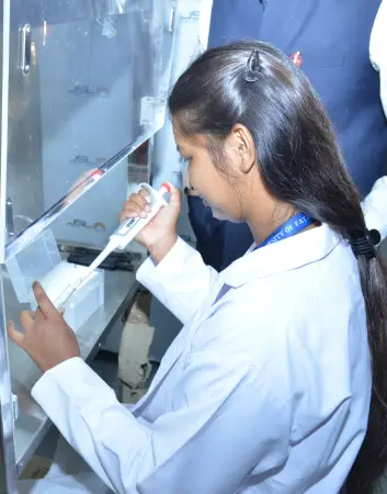 A student conducting laboratory research work at the University of Patanjali using a micropipette for scientific analysis