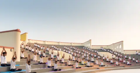 Students practicing yoga in a Gurukul-style setting blending ancient wisdom with modern education at University of Patanjali.